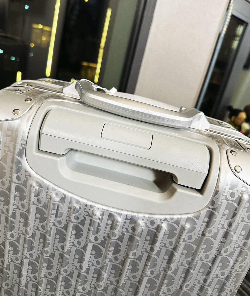 Mala Dior And Rimowa Carry-On Suitcase