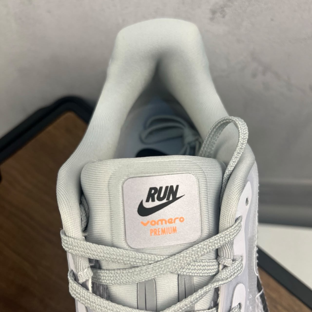 Tênis Nike Zoom Vomero 5 Premium branco e laranja.